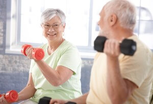 elderly people lifting weights