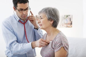 doctor checking patient with stethoscope